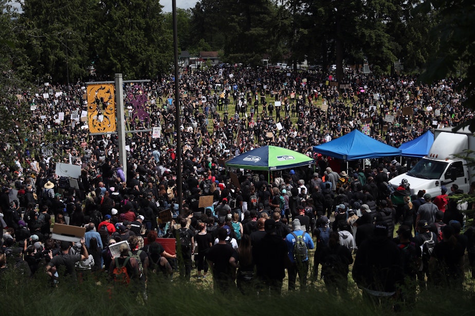 caption: Thousands of people gather in Othello Park in South Seattle ahead of a march on Sunday, June 7, 2020.