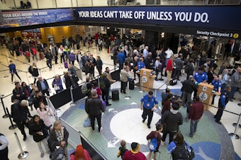 caption: A line forms at security checkpoint 3 on Wednesday, December 13, 2017, at Seattle-Tacoma International Airport. 