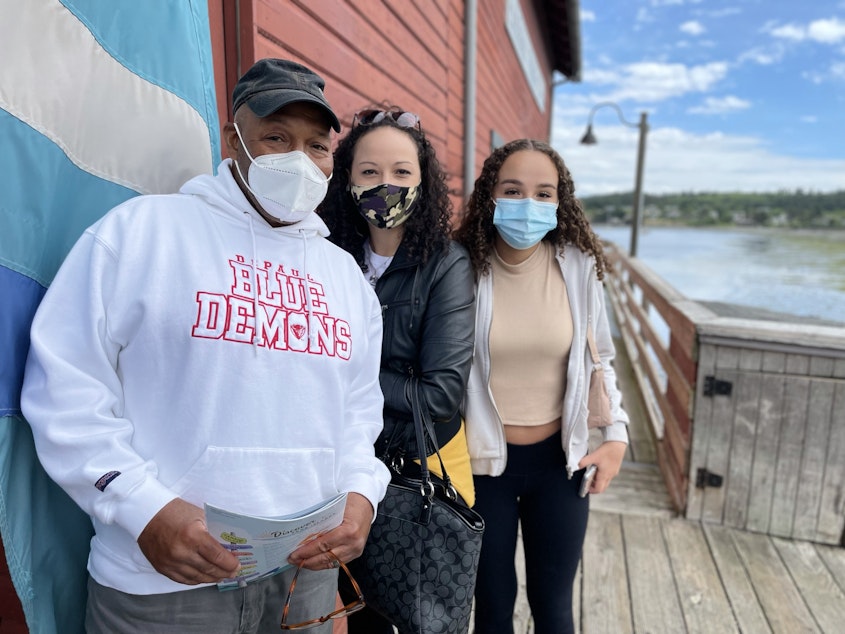 caption: Tourists on Coupeville's historic wharf, just off Front Street. They are Darren Humes of Florida, with his daughters Marie Mucciante and London Flowers from Illinois.
