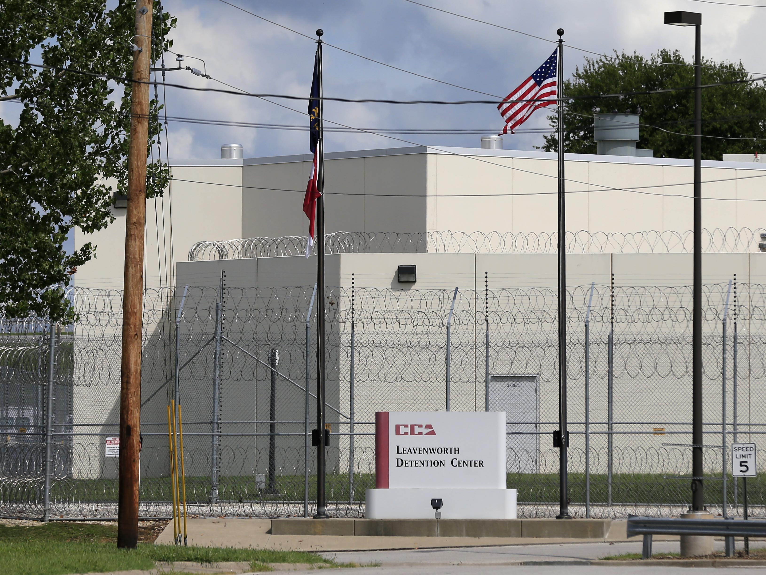 caption: The main gate of the  privately-run Leavenworth Detention Center  in a 2016 file photo. At the time, the prison's operator was known as the Corrections Corporation of America but has since been renamed CoreCivic. Legal advocates are hoping the  facility shuts down when its federal contract ends at the end of the 2021.