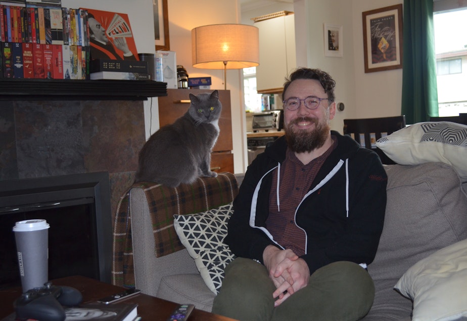 caption: Evan Pulgino lives with his cat Vigo in White Center. Within a week of the Supreme Court's Dobbs ruling ending the right to an abortion in the U.S., he scheduled a vasectomy.