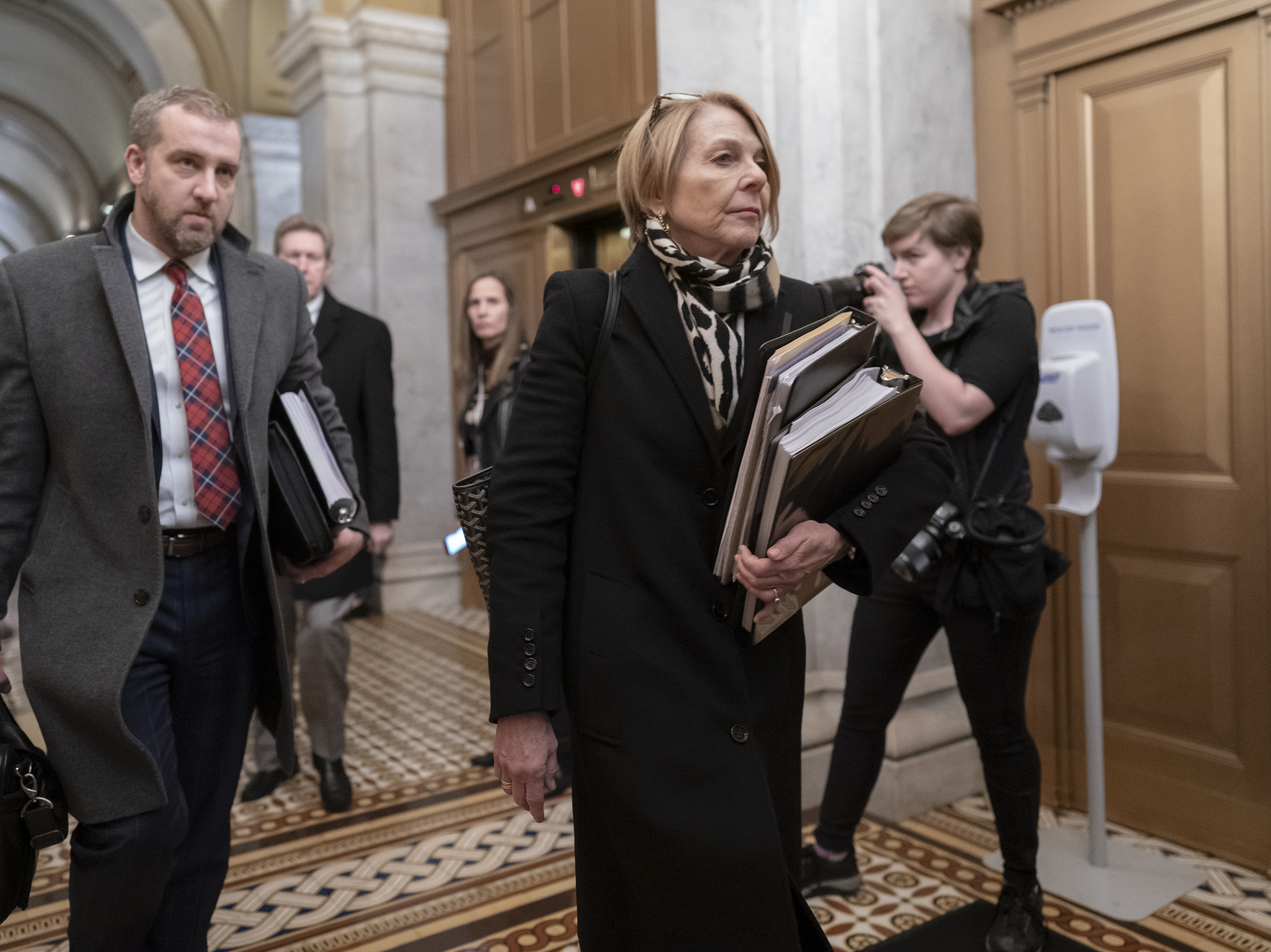 caption: Jane Raskin, a lawyer defending President Trump in his impeachment trial, departs the Senate following opening arguments Saturday.