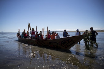caption: Members of the 'Emma canoe' arrive on the shore of the Tsawwassen Indian Reserve after the first leg of their multi-day canoe journey on Thursday, July 27, 2017, in Tsawwassen, British Columbia.