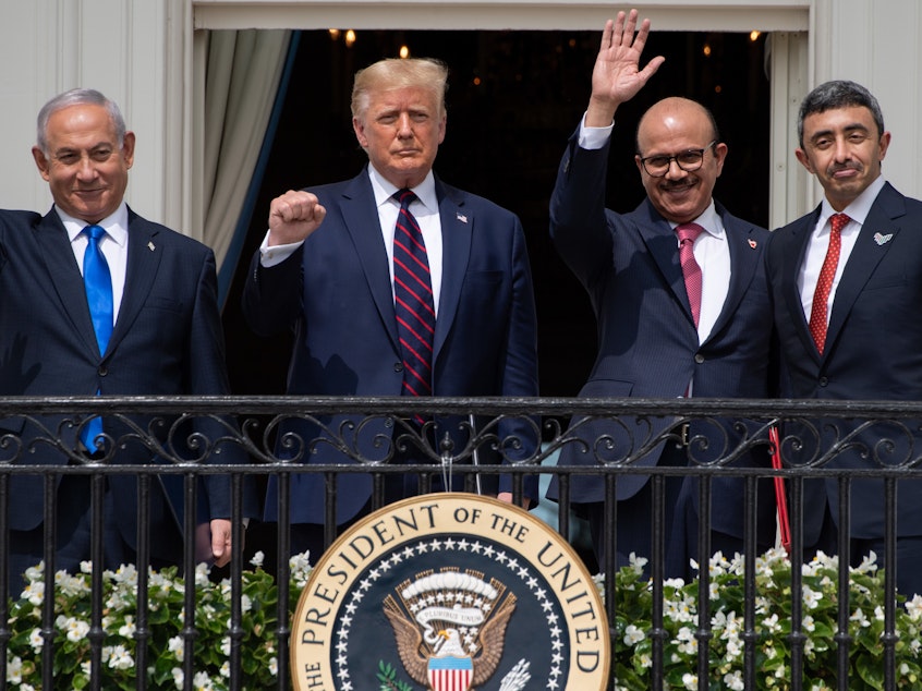 caption: Israeli Prime Minister Benjamin Netanyahu, President Trump, Bahrain Foreign Minister Abdullatif bin Rashid Al Zayani, and UAE Foreign Minister Abdullah bin Zayed Al Nahyan wave from the Truman Balcony at the White House. The group participated in the signing of the Abraham Accords Tuesday.
