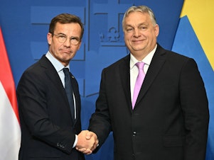 caption: Swedish Prime Minister Ulf Kristersson (left) meets Hungarian counterpart Viktor Orban on Feb. 23, ahead of Monday's key vote in Hungary's parliament on Sweden's bid to join NATO.