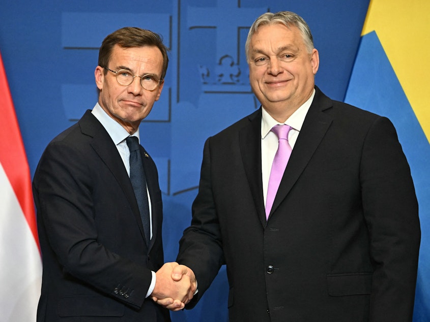 caption: Swedish Prime Minister Ulf Kristersson (left) meets Hungarian counterpart Viktor Orban on Feb. 23, ahead of Monday's key vote in Hungary's parliament on Sweden's bid to join NATO.