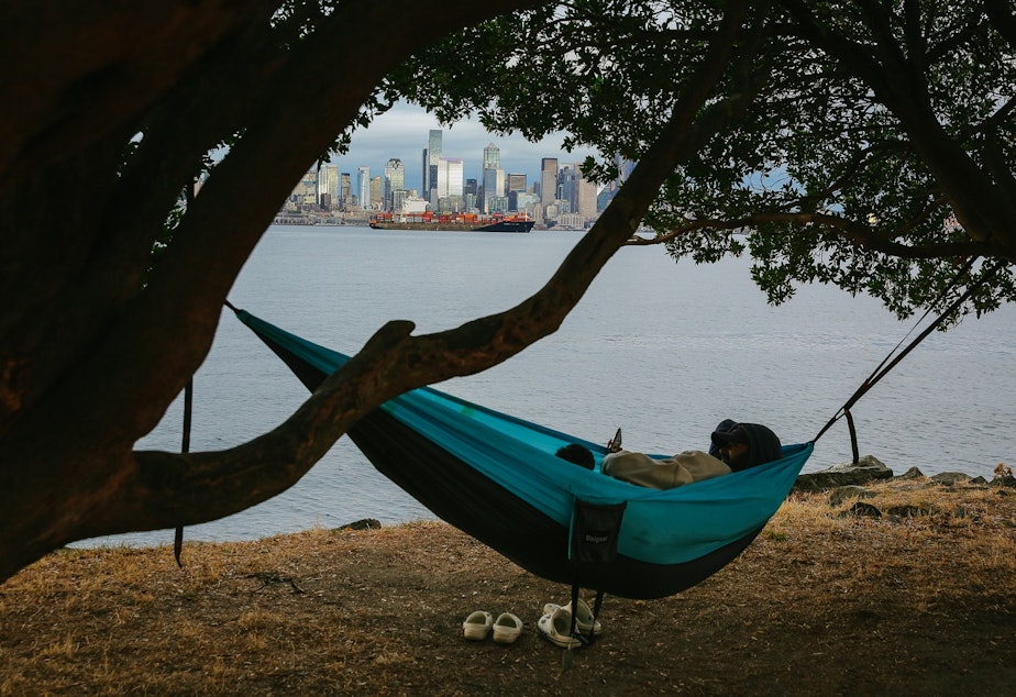 caption: Christian Zumbado and Monse Aguilar relax in a hammock off of Harbor Avenue SW in the Alki neighborhood of West Seattle, September 14, 2021.
