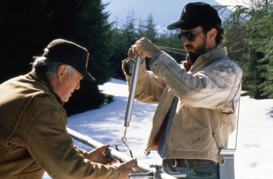 caption: Workers measuring snowpack, 1990