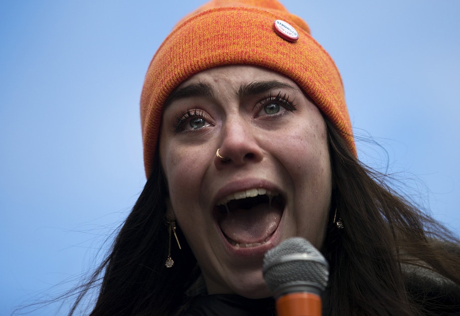 caption: Scout Smissen, a 17-year-old junior at Roosevelt High School becomes emotional while speaking to a crowd of hundreds on Wednesday, March 14, 2018, at Red Square on the University of Washington campus in Seattle. Click on the first image to see more.