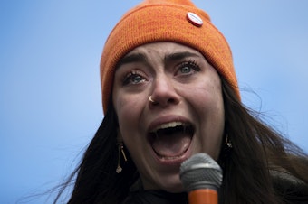 caption: Scout Smissen, a 17-year-old junior at Roosevelt High School becomes emotional while speaking to a crowd of hundreds on Wednesday, March 14, 2018, at Red Square on the University of Washington campus in Seattle. Click on the first image to see more.