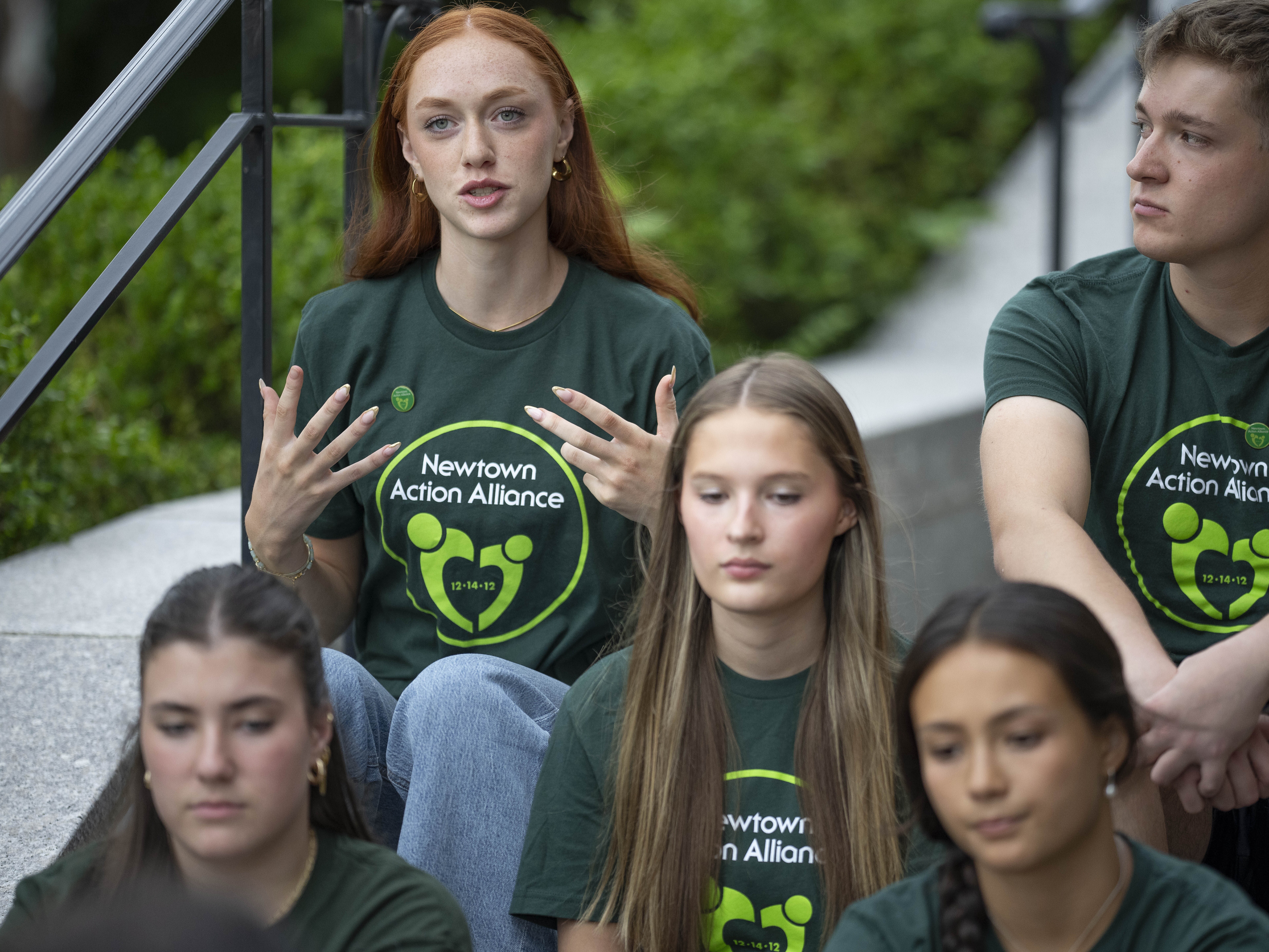 caption: Ella Seaver shares her thoughts on high school graduation with other survivors of the 2012 Sandy Hook Elementary School shooting before a rally against gun violence on Friday, June 7, 2024, in Newtown, Conn.