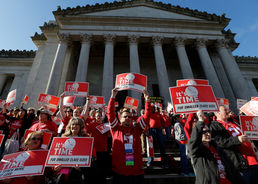 caption: Hundreds of Washington state teachers and other supporters fill the steps of the Legislative Building as they cheer and hold signs Saturday, April 25, 2015 at a Washington Education Association rally at the Capitol in Olympia, Wash.