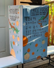 caption: A Seattle Community Fridge, freshly painted and about to be placed at the Danny Woo Community Garden.