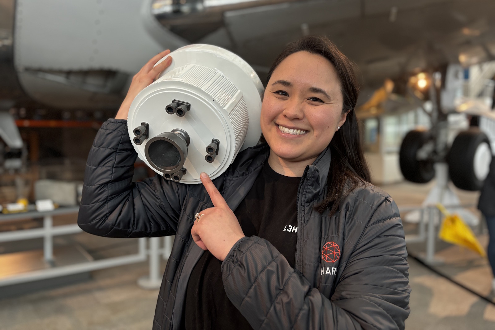 caption: At the Museum of Flight in Tukwila, Jennifer Domanowski of L3Harris points to one of many parts on the Artemis 3 mission that came from her company.