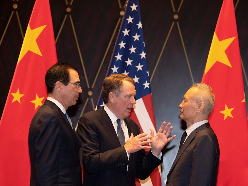 caption: U.S. Treasury Secretary Steven Mnuchin (left) looks on as U.S. Trade Representative Robert Lighthizer speaks with and Chinese Vice Premier Liu He in Shanghai on Wednesday.