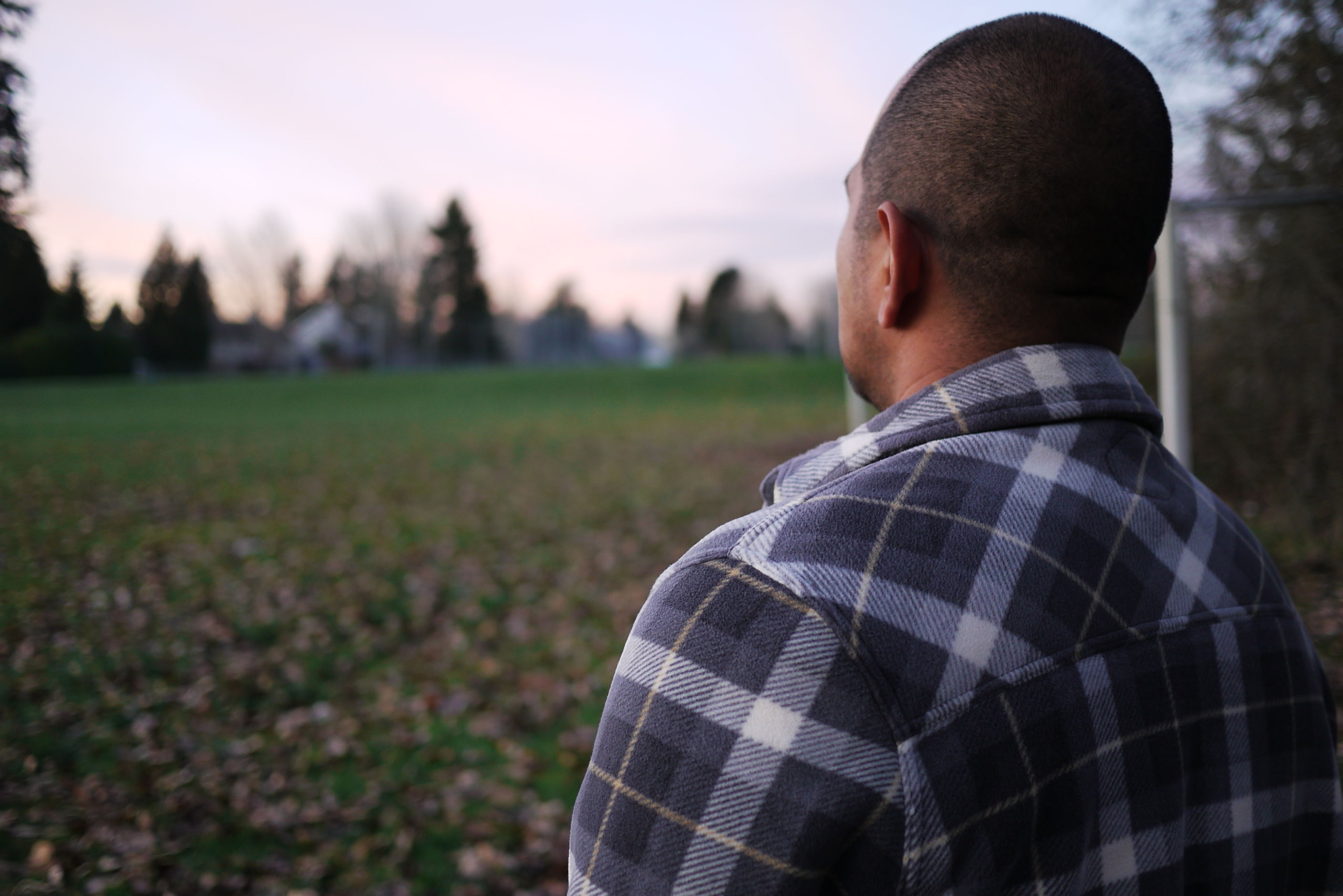 caption: An undocumented father outside the school where he works as a custodian.