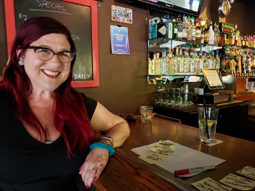 caption: Dana Bos preparing to host her first debate watch party at Tarasco in Ballard.