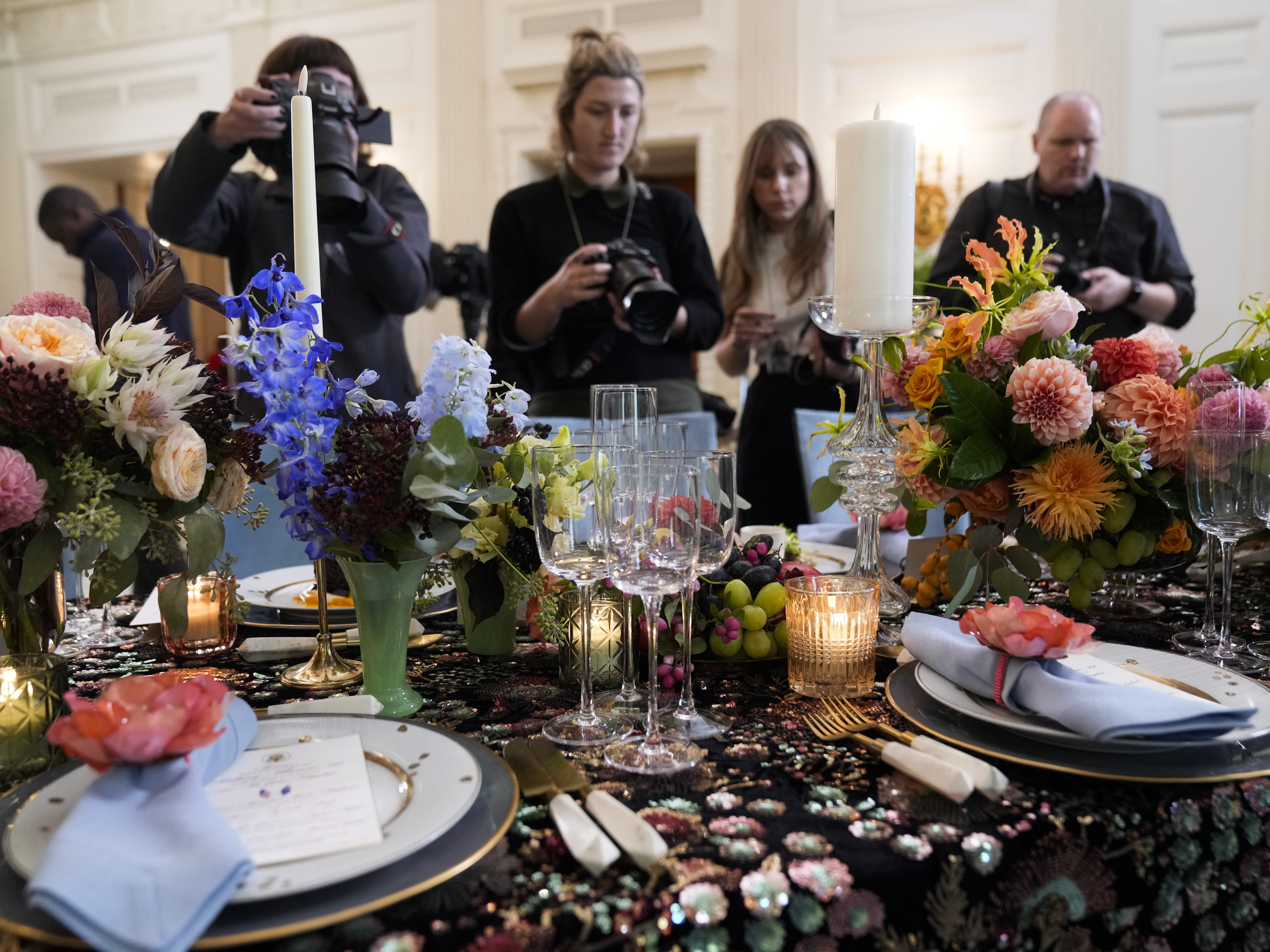 caption: Reporters get a sneak peek at the table setting and menu for President Biden's state dinner for Australia's Prime Minister Anthony Albanese on Oct. 24, 2023.