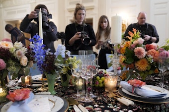caption: Reporters get a sneak peek at the table setting and menu for President Biden's state dinner for Australia's Prime Minister Anthony Albanese on Oct. 24, 2023.
