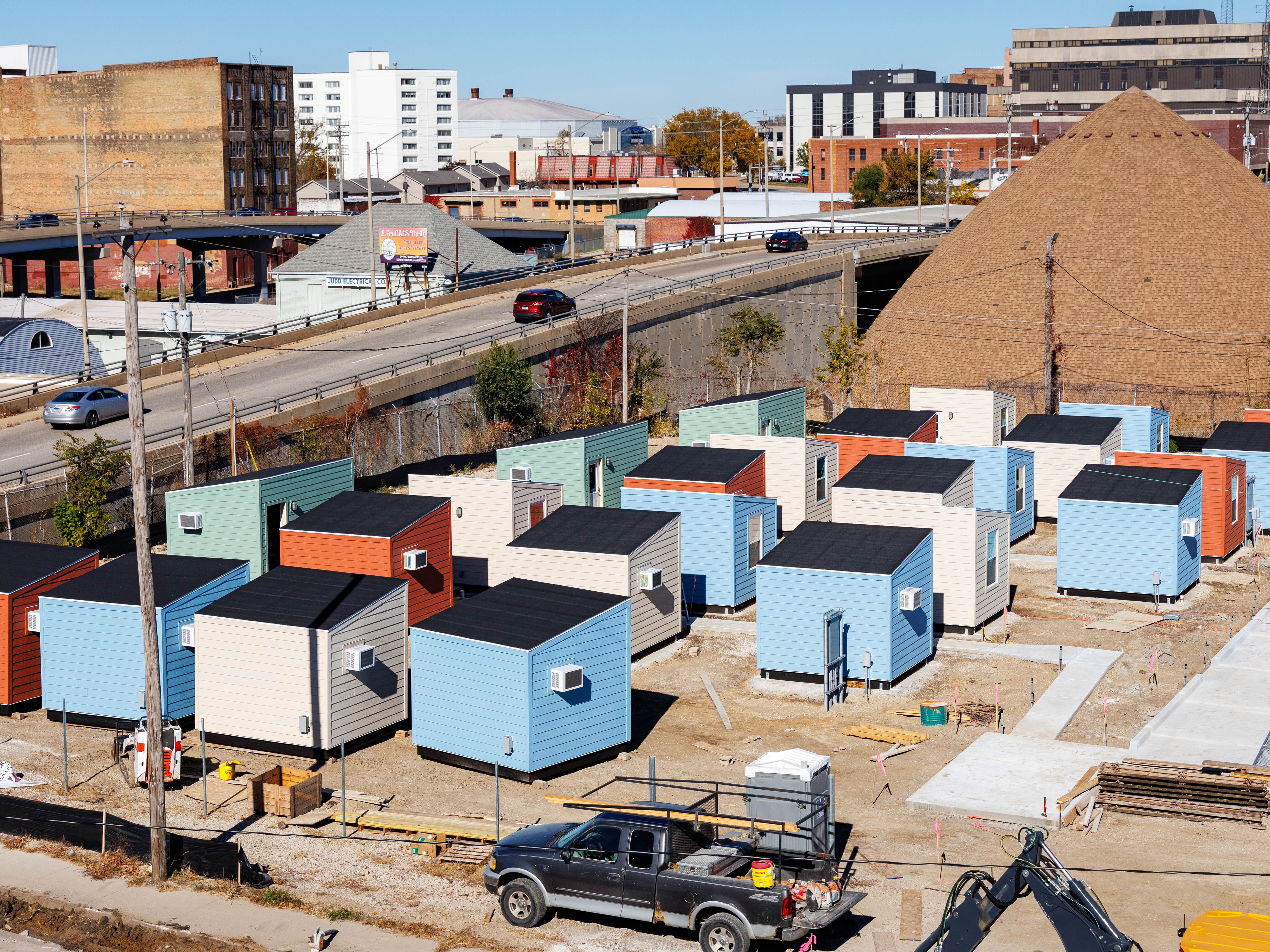 caption: Tiny, colorful cabins make up Home Sweet Home Ministries' shelter village, The Bridge, in Bloomington, Illinois. Construction began in the summer of 2025.