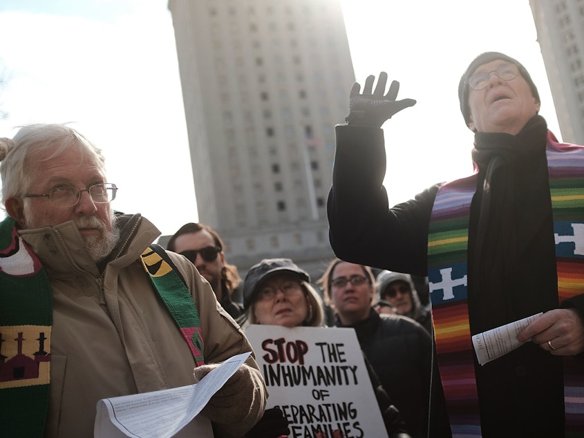 caption: Dozens of clergy members, immigration activists and others participate in a protest against the imprisonment and potential deportation of an immigration activist. Religious liberals are becoming increasingly outspoken in their opposition to many Trump Administration policies.