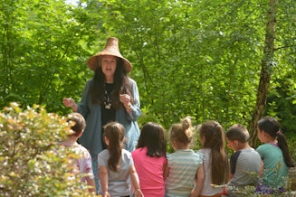caption: Barbara Lawrence sharing stories to the children of the Suquamish Tribe of Indians. 