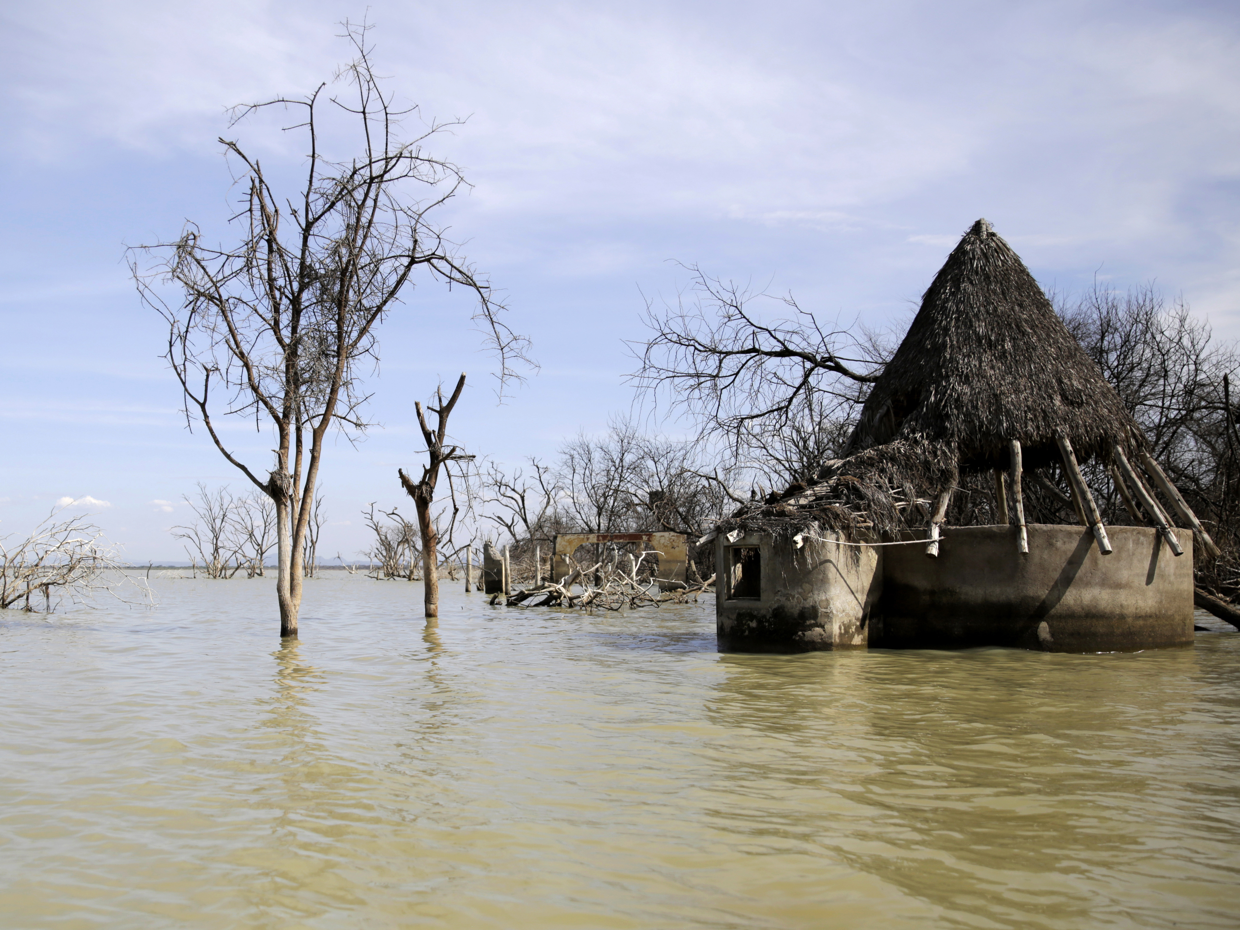 caption: An old hotel is submerged by rising water levels in Lake Baringo in Kampi ya Samaki, Kenya on July 20, 2022.