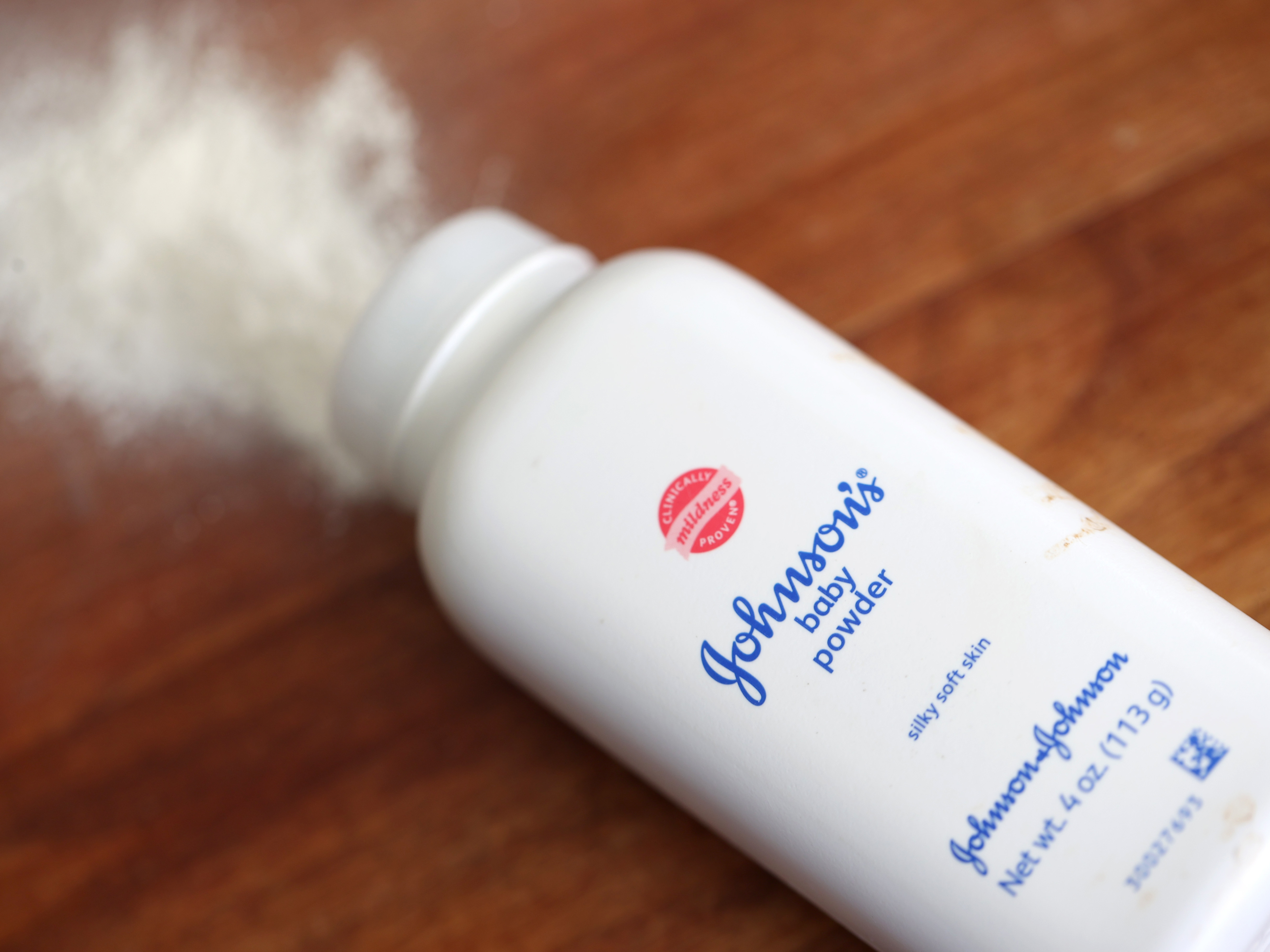 caption: Johnson & Johnson's baby powder is displayed on a table in this photo illustration. A federal judge has allowed Johnson & Johnson's spinoff of a unit to proceed with a controversial bankruptcy.