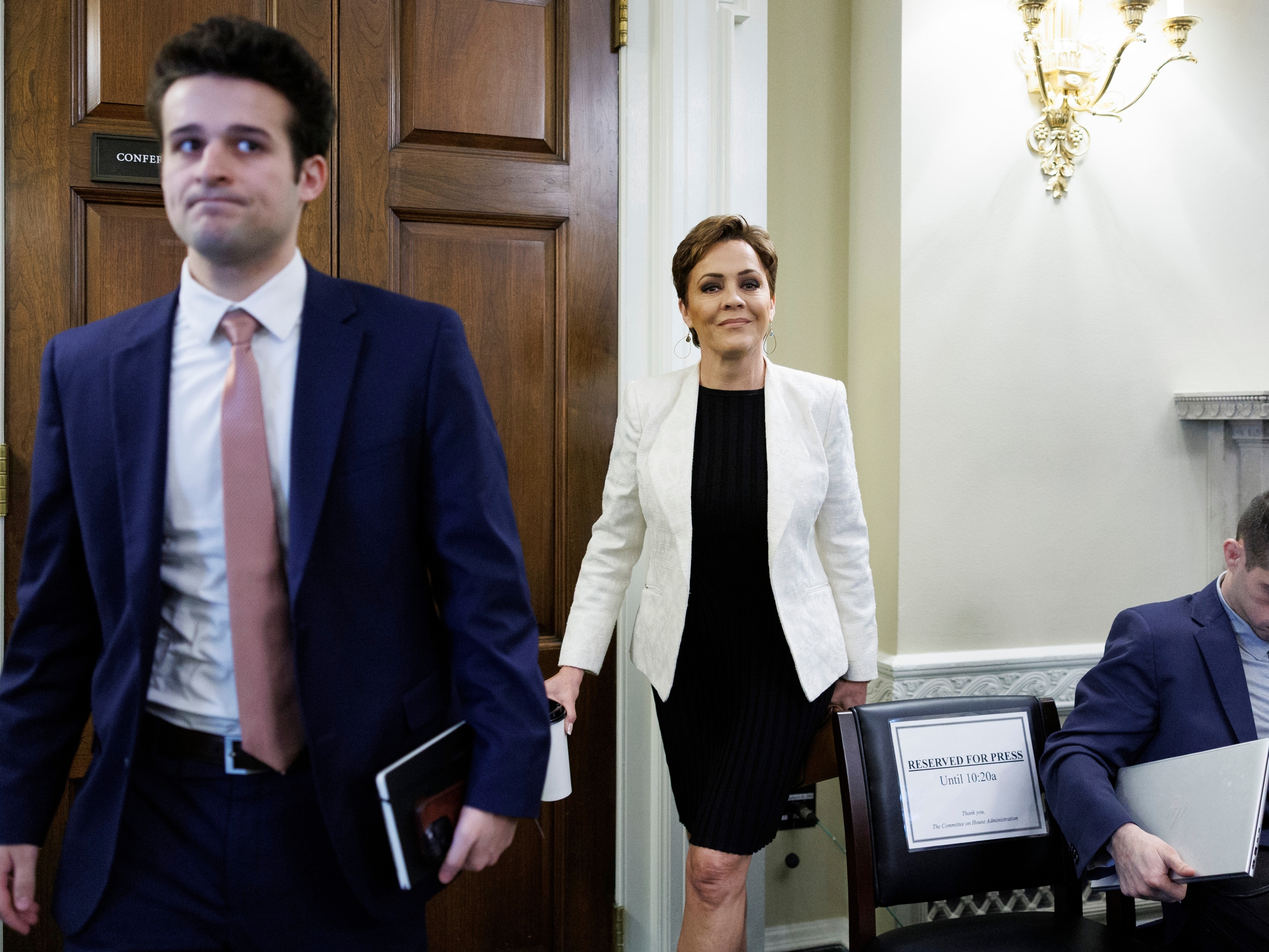 caption: Kari Lake, senior adviser for the U.S. Agency for Global Media, departs following a House Committee on House Administration hearing on federal elections on Capitol Hill, Tuesday, Feb. 10, 2026, in Washington.
