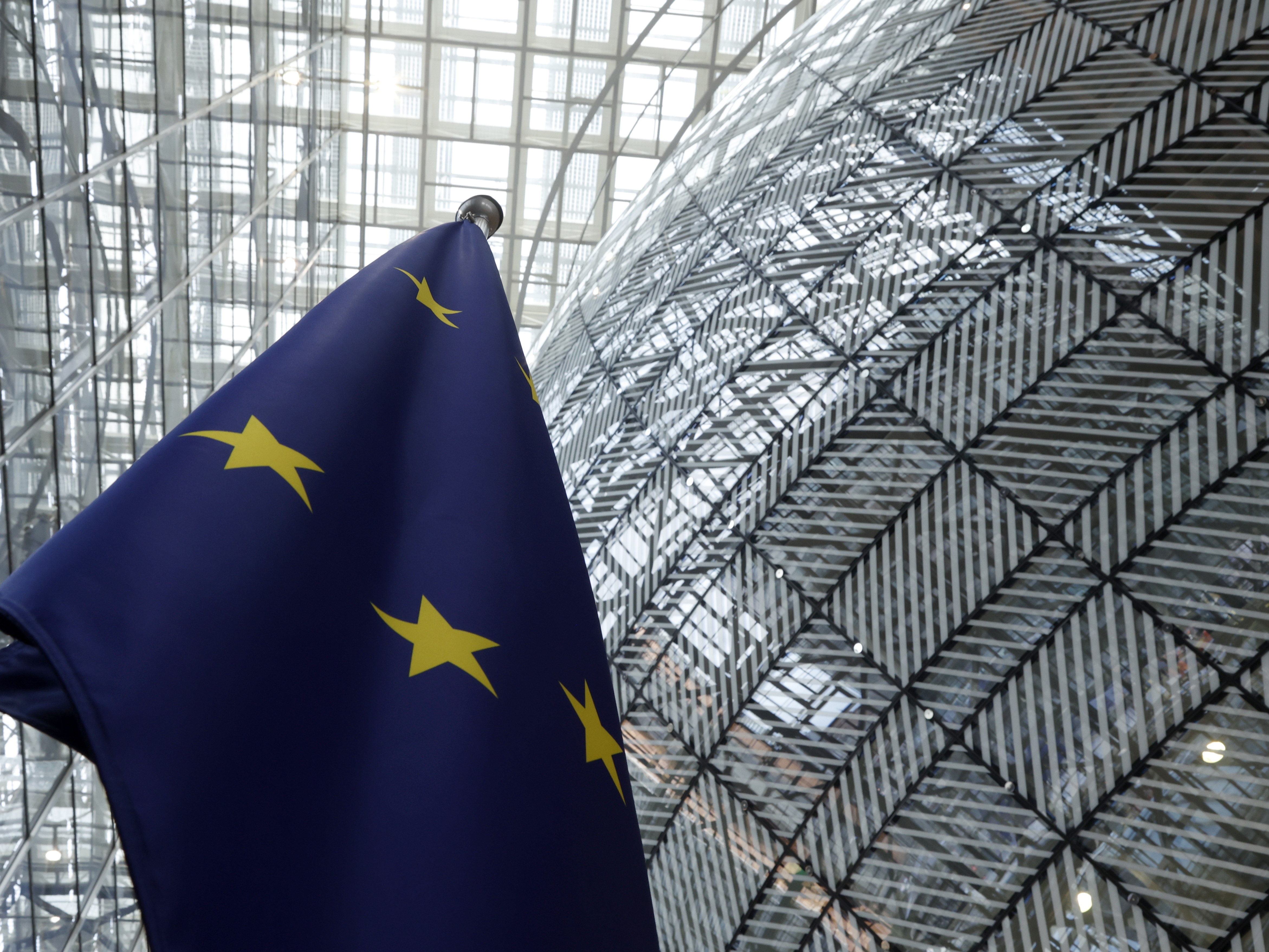 caption: The European Union flag stands inside the atrium at the European Council building in Brussels, June 17, 2024.