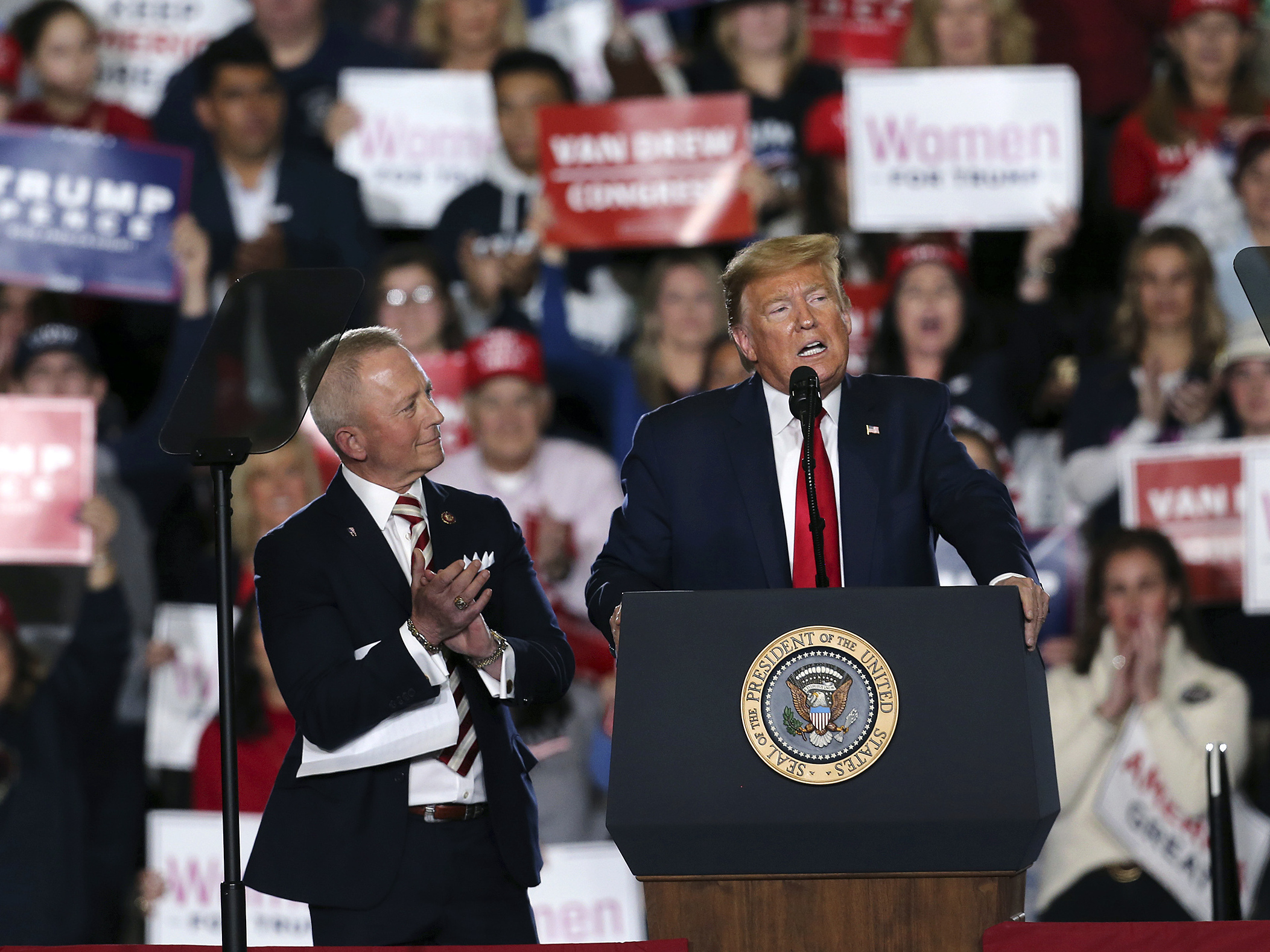 caption: President Trump speaks at a Jan. 28 campaign rally in Wildwood, N.J., as Rep. Jeff Van Drew, R-N.J., listens. Trump backed Van Drew after he switched parties.