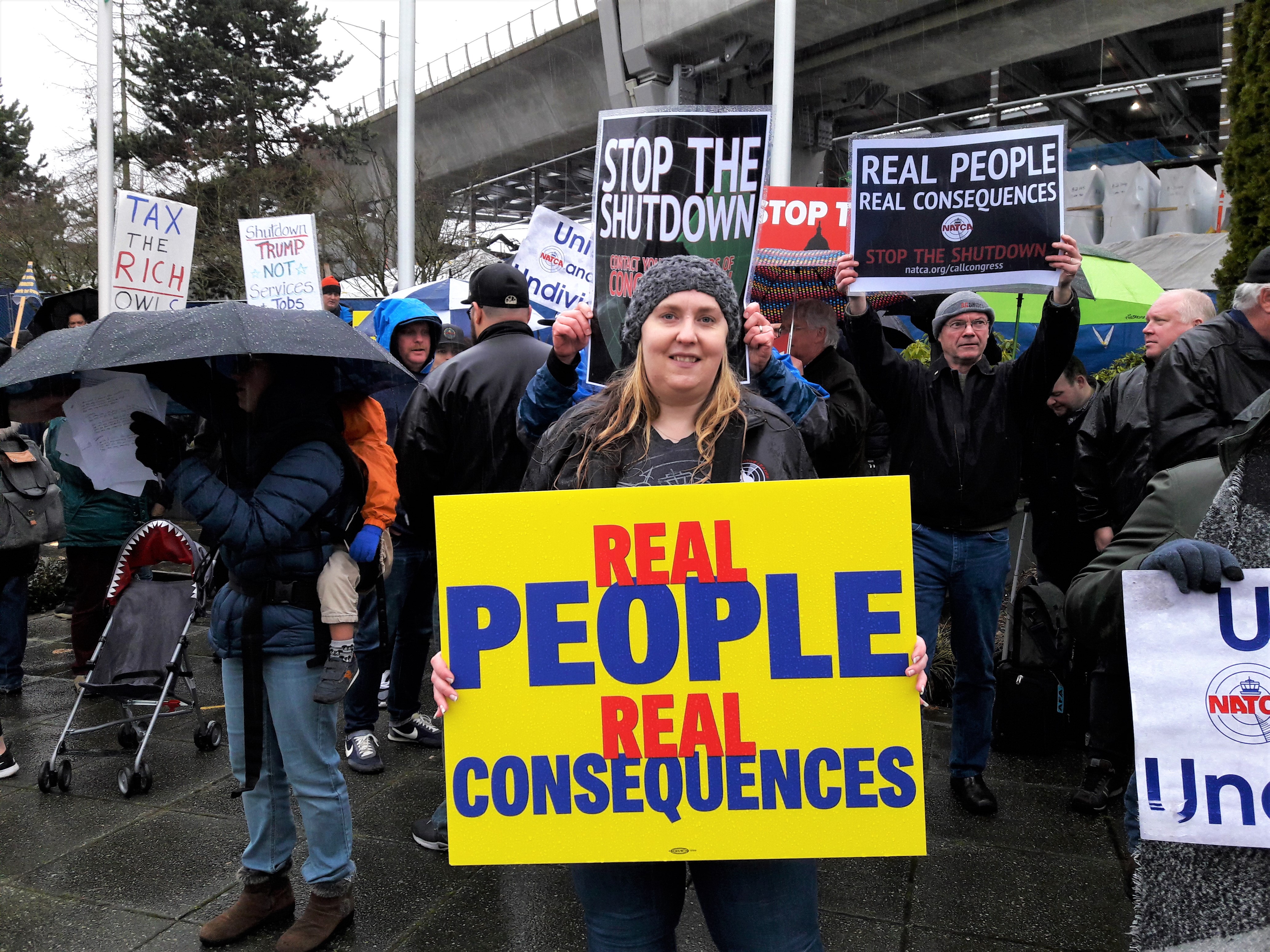 caption: Sherri O'Neil in air traffic controller in Auburn. She's been working for 33 days without a paycheck. "You definitely feel a weight of stress in the building, but I feel like everybody's been there for each other," O'Neil says, "everybody just talks a little bit nicer, extra smile or 'hello, or how are you doing?' So we've been there for each other trying to lift each other up through this."