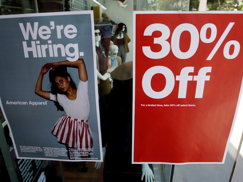 caption: Signs in the window of a retail store offers discounts, and jobs, in Santa Monica, Calif. U.S. GDP grew at a record-setting rate, reflecting pent-up activity after the coronavirus lockdowns, but economists warn of trouble ahead.