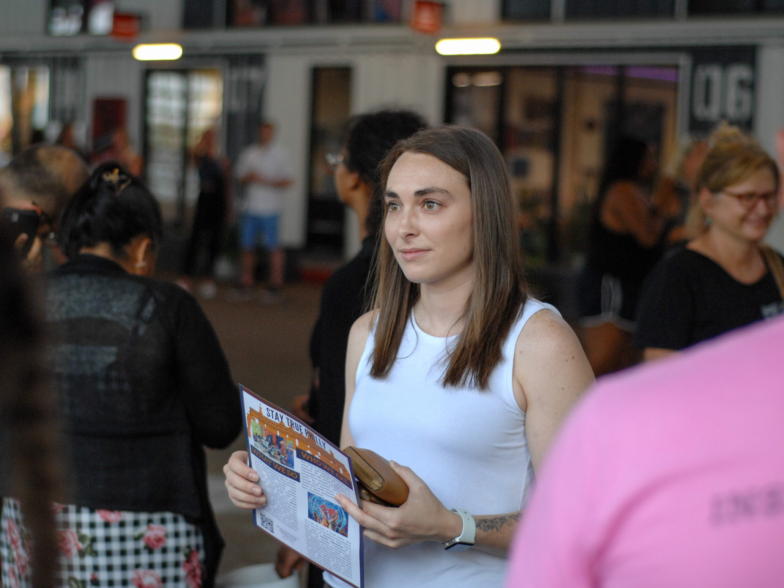 caption: Alexandra Hunt listens to the concerns of Philadelphians during a rally in support of Philly students at the Cherry Street Pier in Pennsylvania on July 16, 2021.
