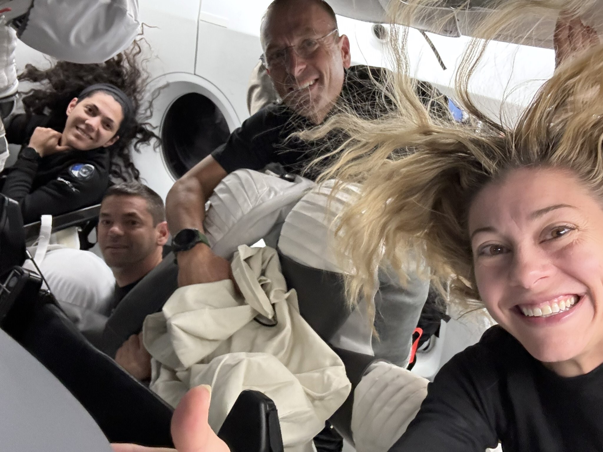caption: In this image posted by SpaceX following the first-ever commercial spacewalk by the Polaris Dawn crew, shows (L-to-R) mission specialist Sarah Gillis, commander Jared Isaacman, pilot Scott Poteet and mission specialist Anna Menon aboard a SpaceX Crew Dragon capsule.