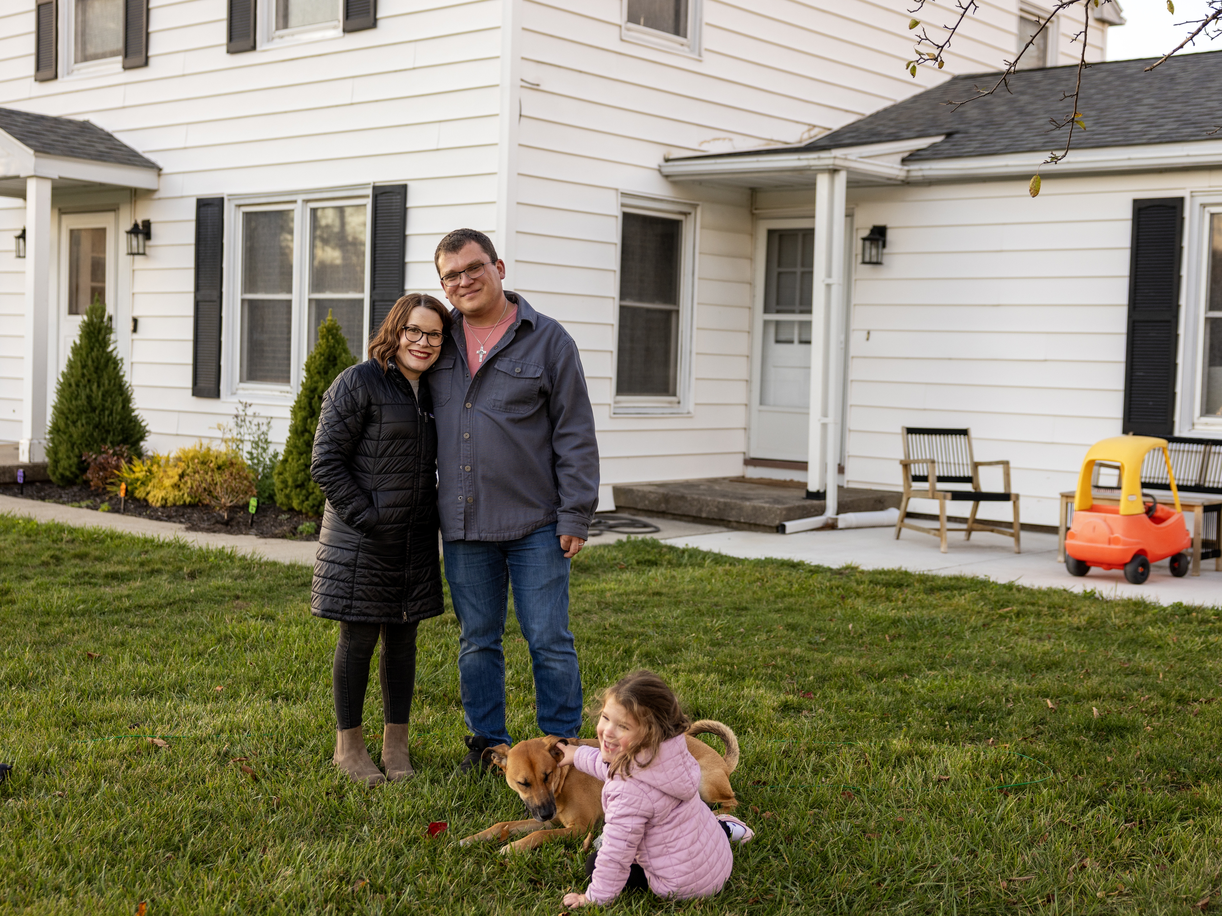 caption: Ashley and Nick Evancho's 3-year-old daughter, Sophia, plays with their dog in front of their home near Buffalo, N.Y. Ashley and Nick have decided to have only one child, a choice many people are making around the world. The trend is triggering an unprecedented shift toward rapidly aging and gradually shrinking populations.