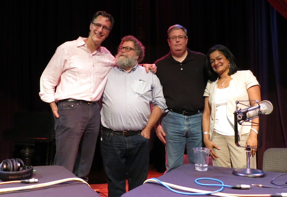 caption: Bill Radke, Knute Berger, Chris Vance and Sen. Pramila Jayapal on stage at the Columbia City Theater on Friday, June 5, 2015.