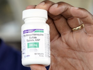 caption: A bottle of hydroxychloroquine is seen outside a nursing home in Texas City, Texas, this month.