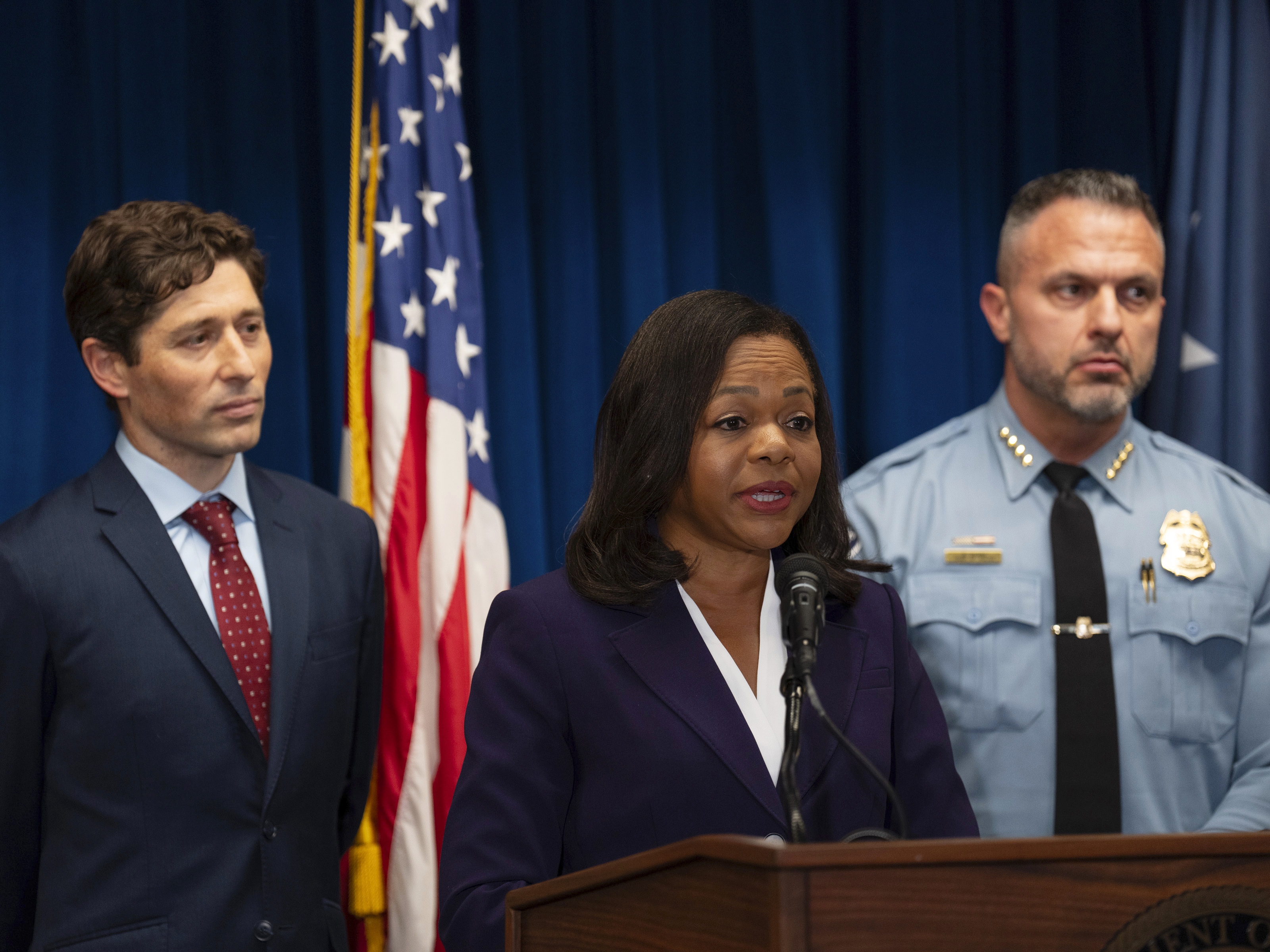 caption: Assistant Attorney General Kristen Clarke of the Justice Department's Civil Rights Division, flanked by Minneapolis Mayor Jacob Frey, left, and Chief Brian O'Hara of the Minneapolis Police Department, speaks at a news conference at the U.S. Courthouse in Minneapolis, Monday, Jan. 6, 2025.