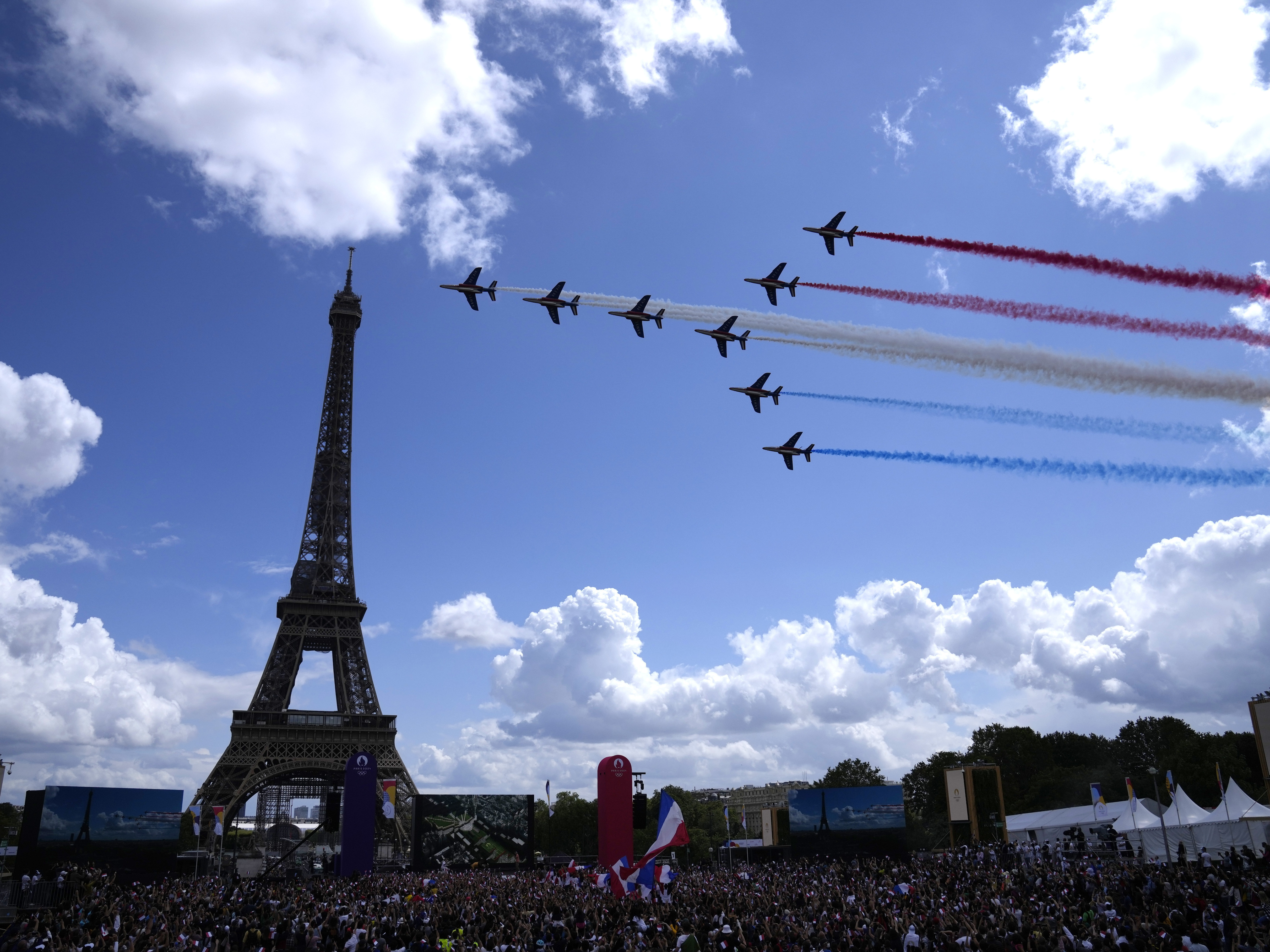 caption: The French Aerial Patrol fly by the Eiffel Tower in Paris as part of the handover ceremony of Tokyo 2020 to Paris 2024, as Paris will be the next Summer Games host in 2024.
