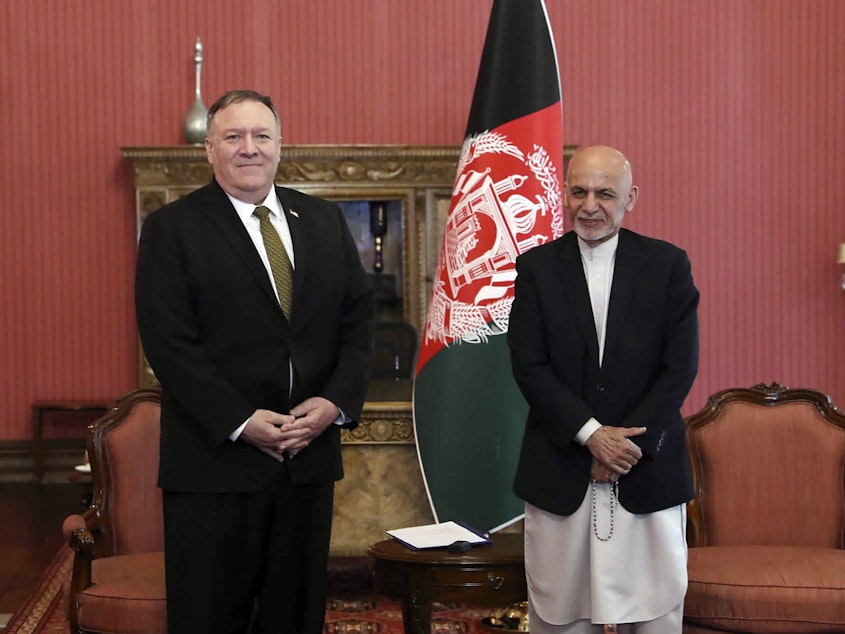 caption: Secretary of State Mike Pompeo, left, stands with Afghan President Ashraf Ghani, at the Presidential Palace in Kabul, Afghanistan, on Monday. Pompeo says the U.S. will cut $1 billion in aid to Afghanistan.