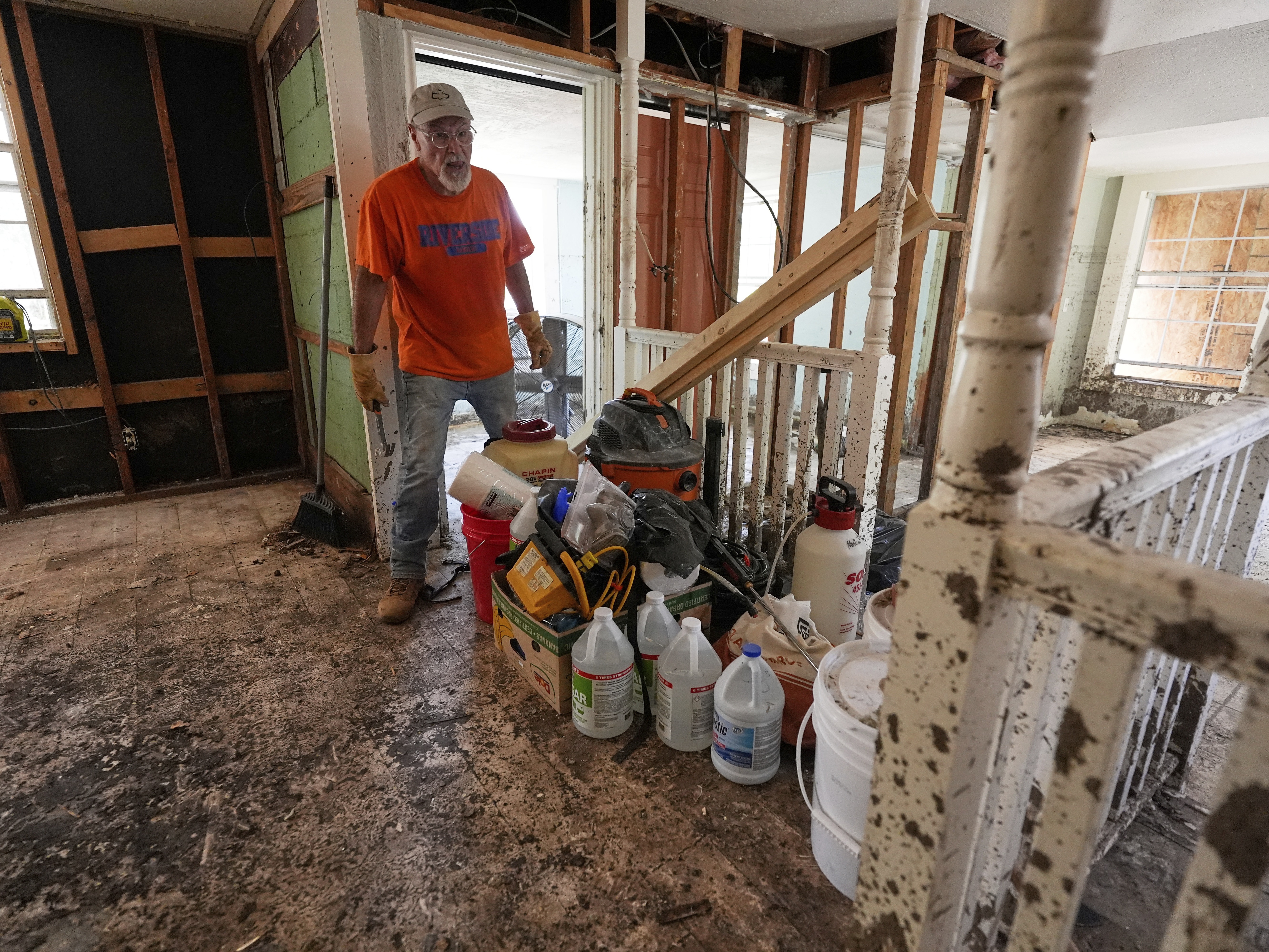 caption: Homeowner Daniel Olivas walks through his home that was heavily damaged from flash floods along the Guadalupe River in Kerrville, Texas, on Thursday, July 10, 2025. Many home buyers in the U.S. do not get information about flood risk before them move in.