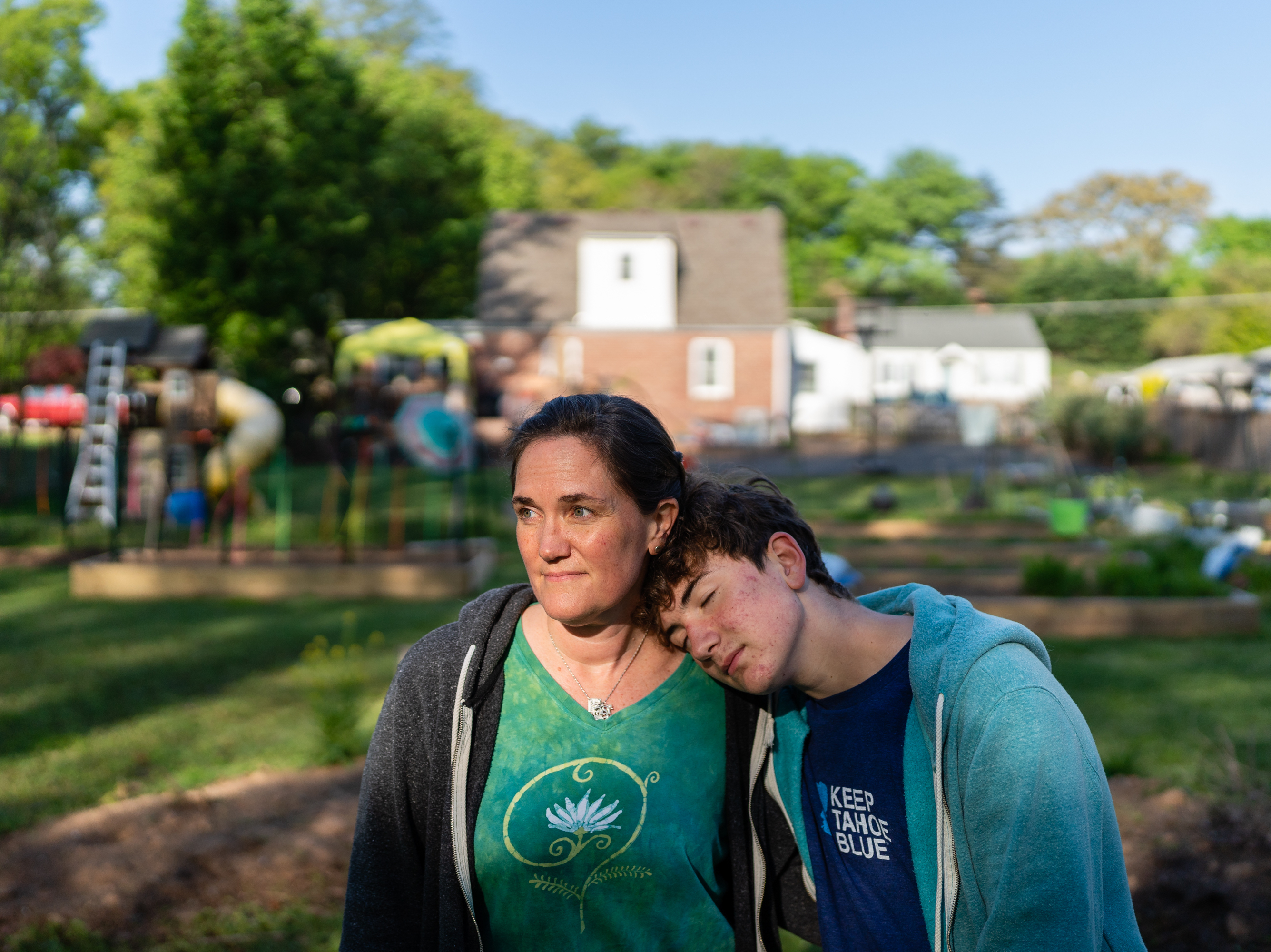 caption: Jenna Fournel and Leal Abbatiello, 14, pose for a portrait at their home in Alexandria, Va. on April 30, 2022. Since the start of the pandemic in 2020, Fournel and her son expanded their garden and began harvesting and giving away produce for free to their community.