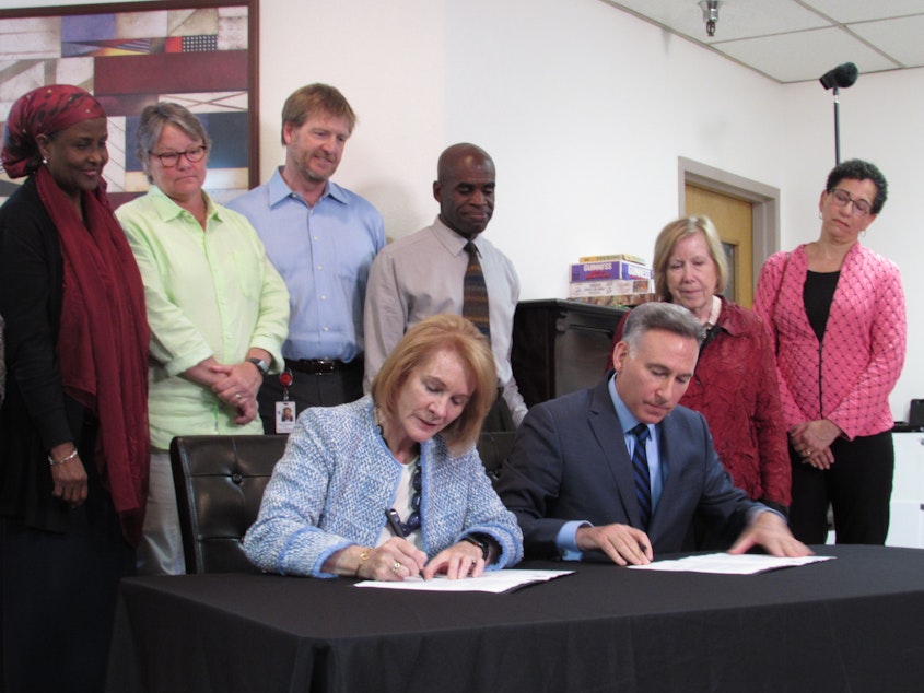 caption: At a Salvation Army shelter, Seattle Mayor Jenny Durkan and King County Executive Dow Constantine signed an agreement pledging to align their homelessness funding process. 