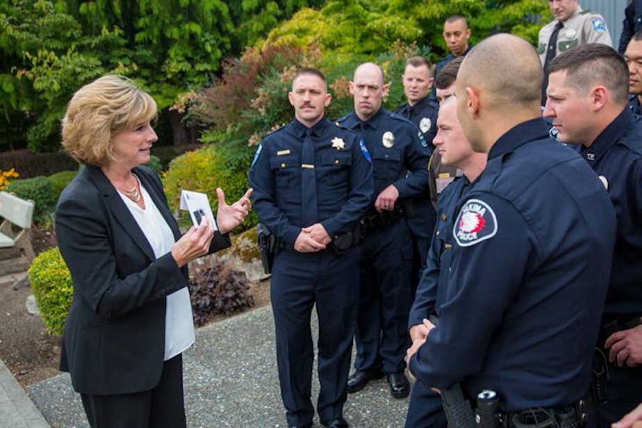 caption: Sue Rahr, left, with police officers.