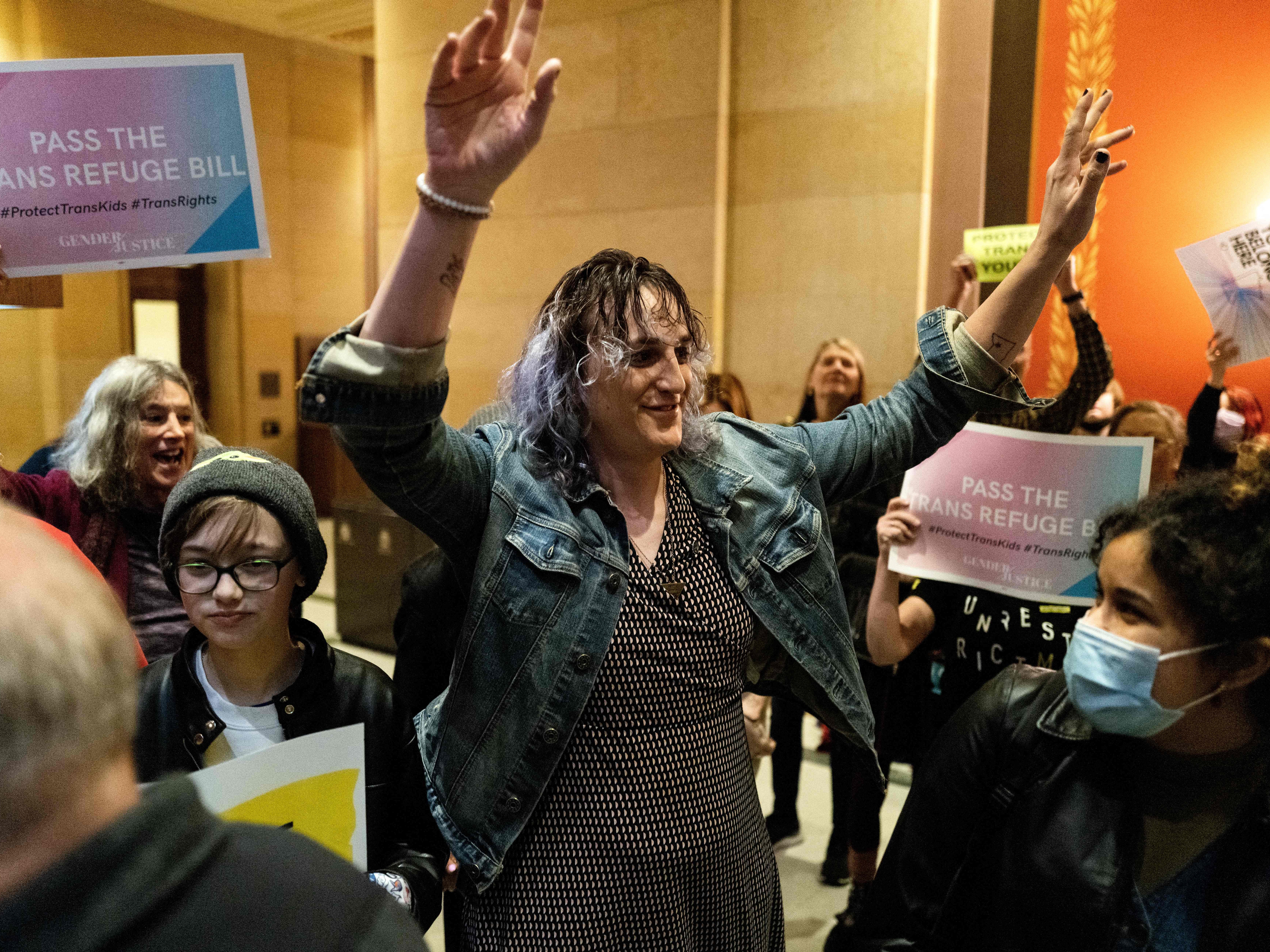 caption: Rep. Leigh Finke, Minnesota's first openly trans legislator, arrives to cheers from supporters just before before the Minnesota Senate introduced the trans refuge bill at the state capitol building in Saint Paul in April 2023. Transgender rights may come up in the vice presidential debate on Tuesday.