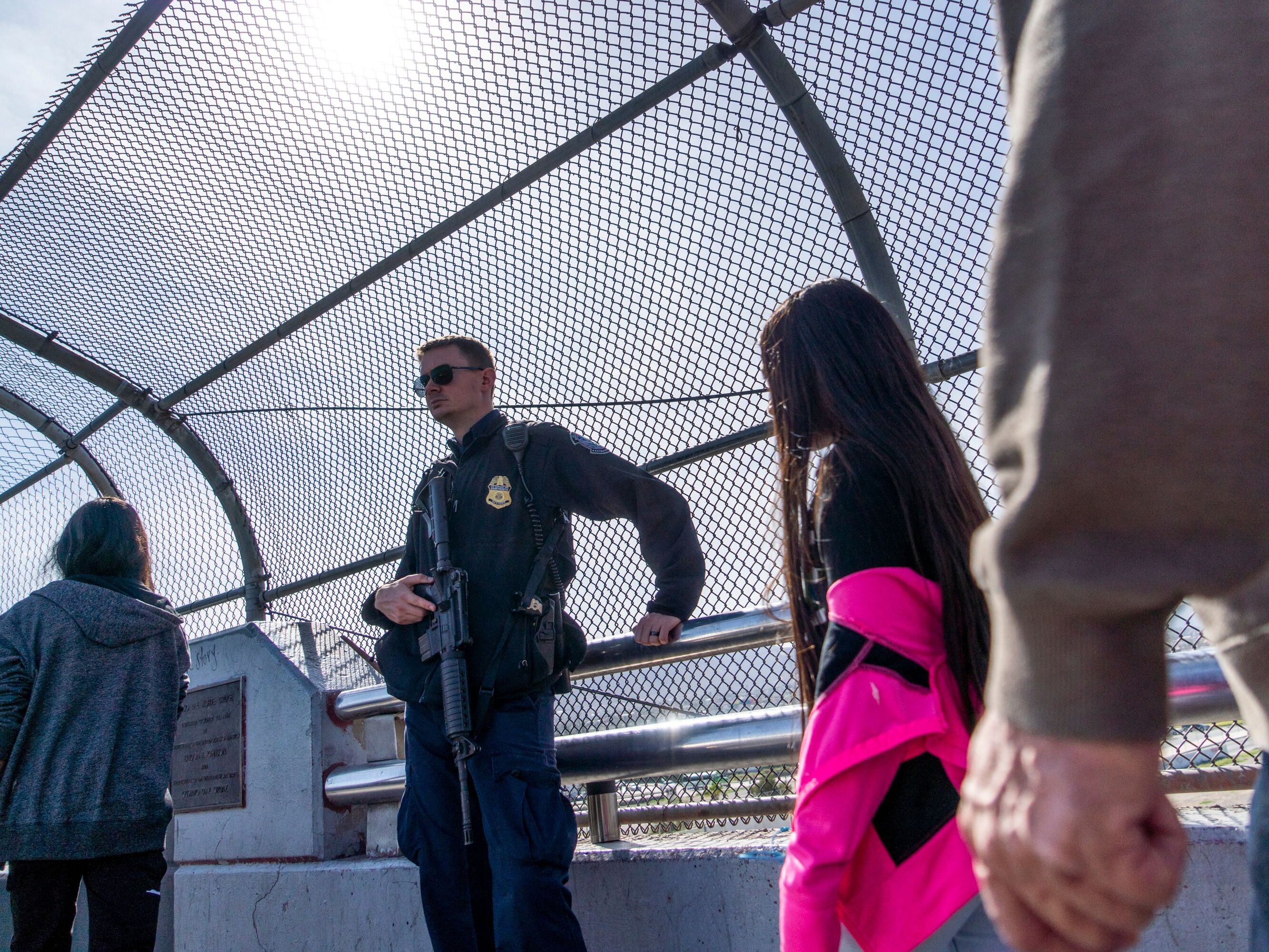 caption: A Customs and Border Protection officer guards the middle of the Paso Del Norte bridge in El Paso, Texas, on Nov. 4, 2018.