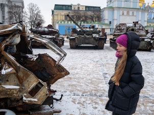 caption: People look at destroyed Russian military vehicles on display in central Kyiv on a snowy afternoon in the capital city on January 9.
