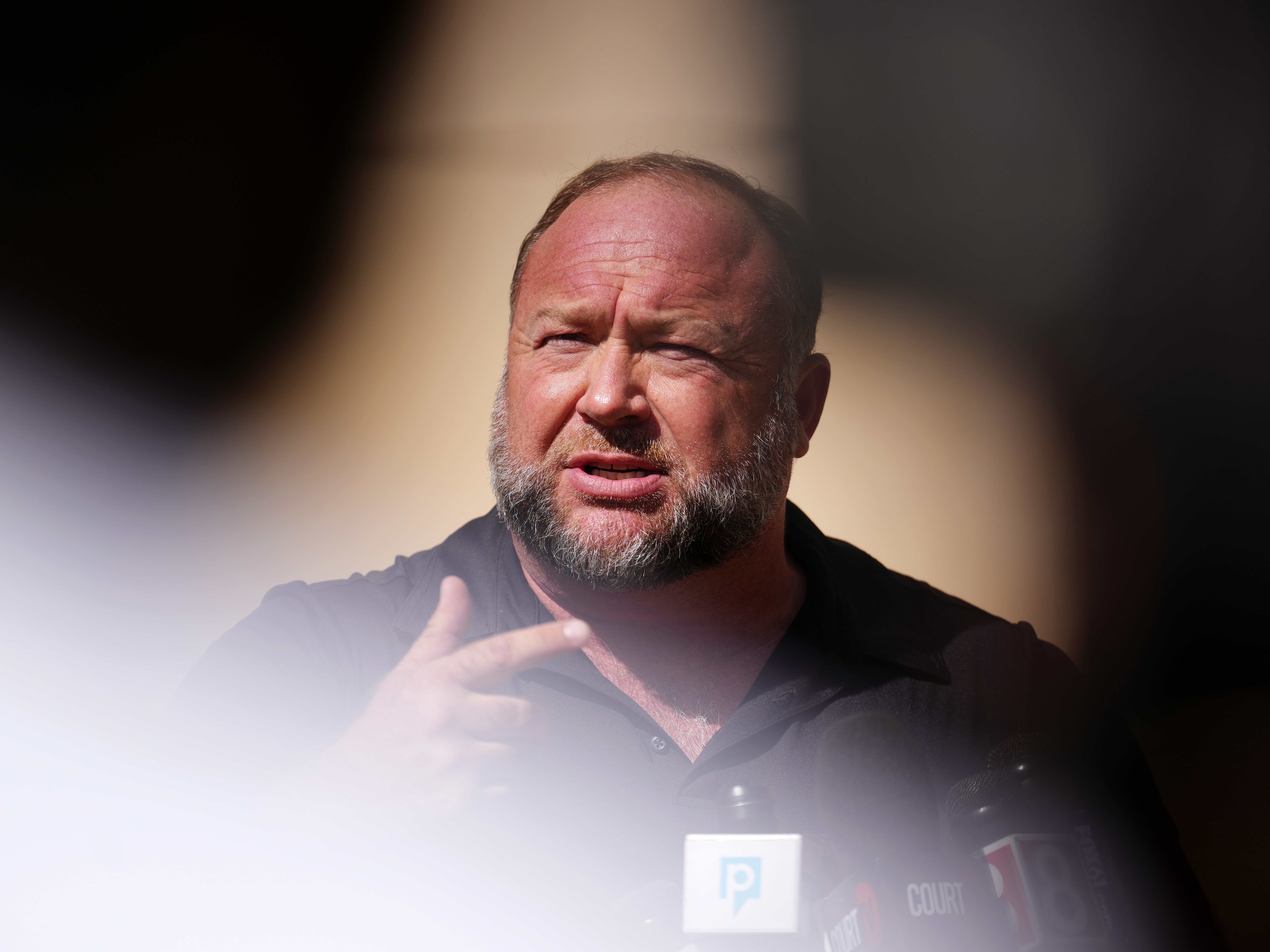 caption: Conspiracy theorist Alex Jones says if his Infowars show is shut down, he'll move to his back-up studios and website and continue posting a live feed on his usual satellites and stations and on X.
