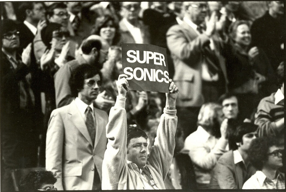 caption: Seattle Sonics fan with sign, circa 1980, the year after the team won the NBA championship.